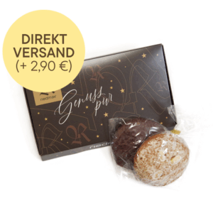 Braune Pappschachtel mit der Aufschrift Genuss pur und davor 2 Lebkuchen – einer mit Vollmilchschokolade, einer gebaselt mit Mandeln. Darüber ein großer runder Button mit dem Text Direkt Versand (+2,90€)